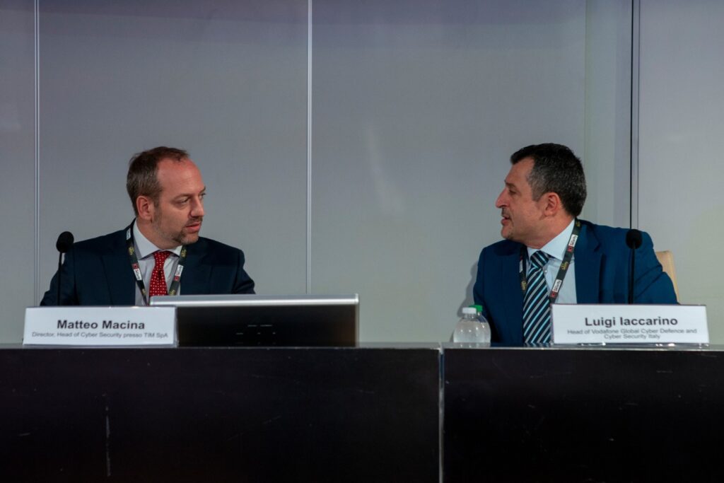 Forum ICT Security 2023: Matteo Macina, Head of Cyber Security presso TIM SpA, discute le sfide di sicurezza nelle infrastrutture Telco, sottolineando l'ampliamento della superficie di attacco con l'avvento del 5G. Macina evidenzia le minacce storiche nei sistemi legacy come reti 2G e 3G, le vulnerabilità dei protocolli di rete, e le sfide umane legate al social engineering. Sottolinea inoltre i problemi di sicurezza nella supply chain, l'impatto dei conflitti globali e le minacce da attori malevoli, tra cui gruppi State-sponsored e organizzazioni criminali. Forum ICT Security 2023: Luigi Iaccarino, Head of Vodafone Global Cyber Defence and Cyber Security Italy, illustra l'evoluzione delle telecomunicazioni in ecosistemi complessi, aumentando le responsabilità dei team di cybersecurity. Le Telco, oltre a fornire comunicazione, offrono servizi diversificati che richiedono una gestione dei rischi ampliata verso il mondo applicativo. Le Telco sono tra le industrie più a rischio APT, con minacce come SIM swapping e spionaggio Nation-State. Iaccarino enfatizza l'importanza di una sicurezza olistica e integrata per mitigare le minacce tempestivamente
